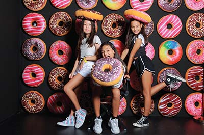 Three girls posing for fun photos in the Donut Room at Selfie Experience Phuket