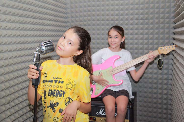 Posing for photos as a singer and guitar player in the music studio at The Selfie Experience Phuket