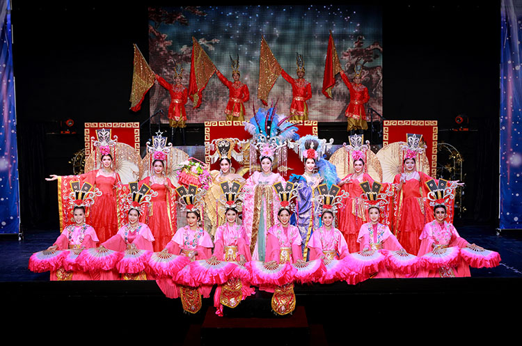 Performers of the Siam Dragon Cabaret show wearing beautiful gowns and headdresses