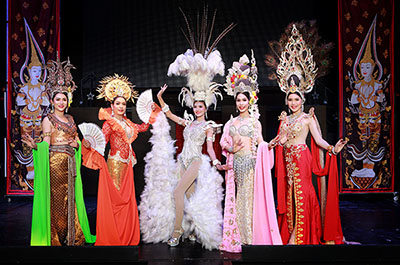 Dancers wearing long gowns and beautiful headdress at the Siam Dragon cabaret show