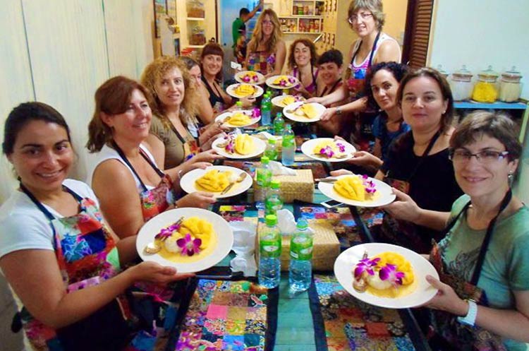 Students at Silom Thai cooking school with a dish just cooked