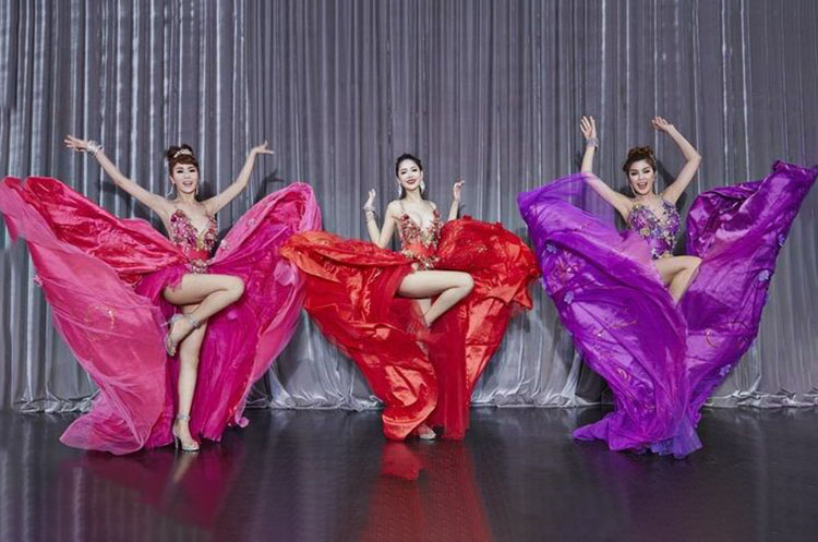 Three dancers on the stage of the Simon Cabaret Show in Phuket