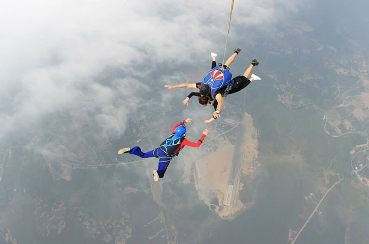 Three skydivers racing towards earth