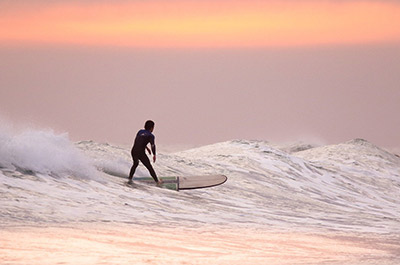 A surfer in the waves at Bang Tao Beach