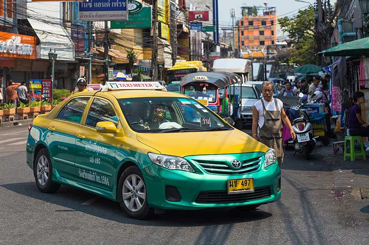 A yellow-green taxi in Bangkok