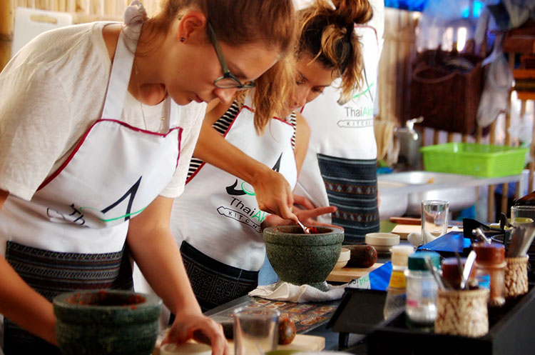 Students preparing a fresh curry paste