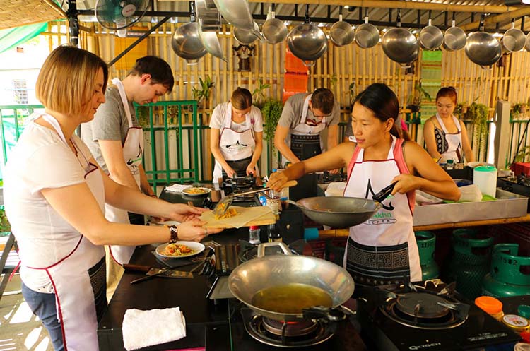 Teacher and students cooking food at Thai Akha Cooking School