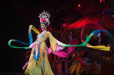 A flamboyant dancer wearing a flashy gown at Tiffany’s Show Pattaya