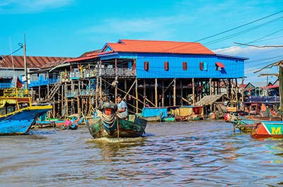 Houses on stilts and boats on the water at Kompong Phluk floating village