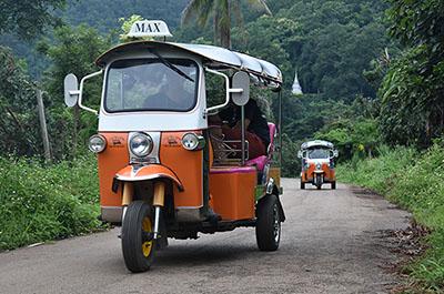 Tuk tuks on a winding road in the countryside of Chiang Mai