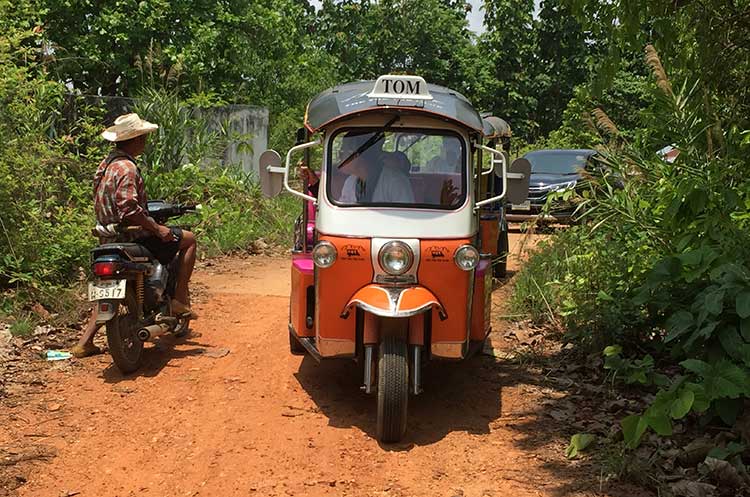 A Tuk Tuk driven on a rural dirt road in Chiang Mai