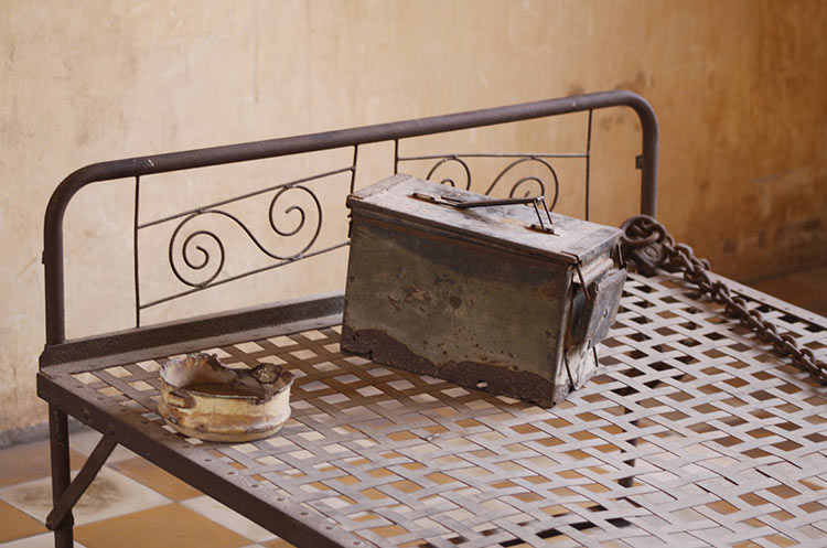 A bed with shackles in a prison cell at Tuol Sleng Genocide Museum