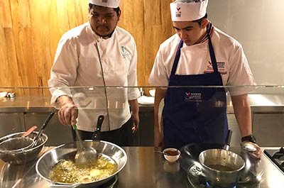 Student and teacher at work in the kitchen of Wandee Cooking School