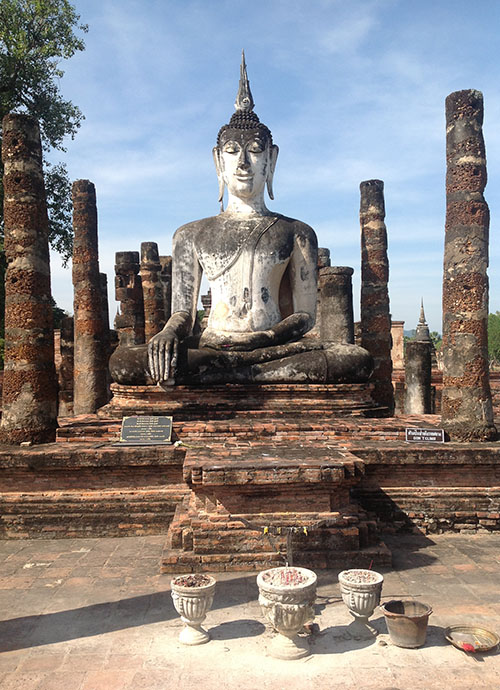 A seated Buddha image in the ruins of the Wat Mahathat at Sukhothai Historical Park