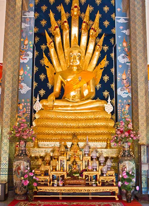 Buddha image sheltered by Naga at Wat Phra That Cho Hae