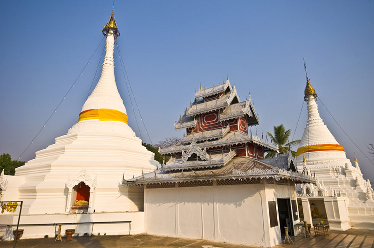 Two chedis and the Burmese style viharn of the Wat Phra That Doi Kong Mu in Mae Hong Son