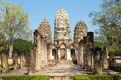 The three Khmer style prangs of the Wat Si Sawai, one of the oldest temples in the Sukhothai Historical Park