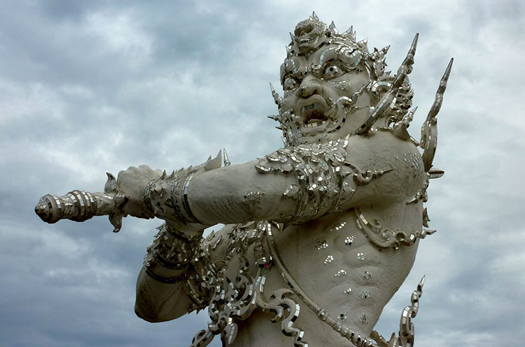 Statue of an armed guardian at the White Temple in Chiang Rai